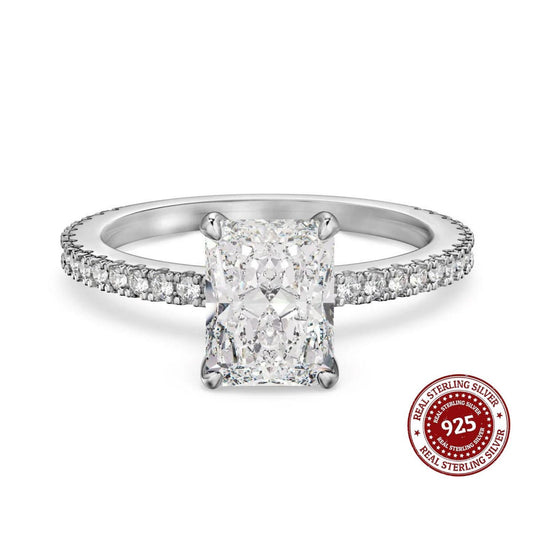 Silver ring with diamond accent on a white background, featuring a 'Real Sterling Silver' stamp.