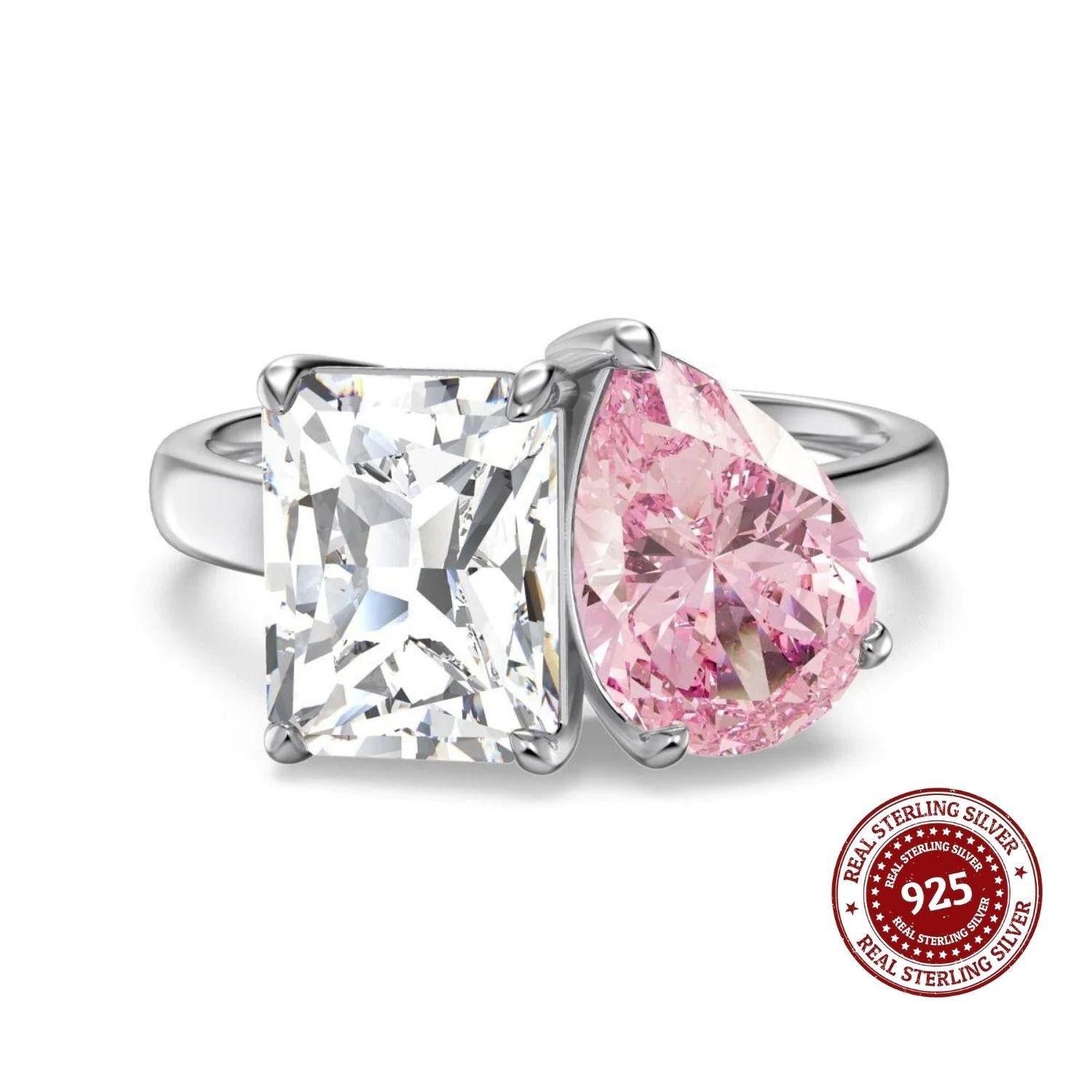 Two diamond rings with a pink gemstone and a clear gemstone, featuring a 'Real Sterling Silver 925' stamp on a white background.