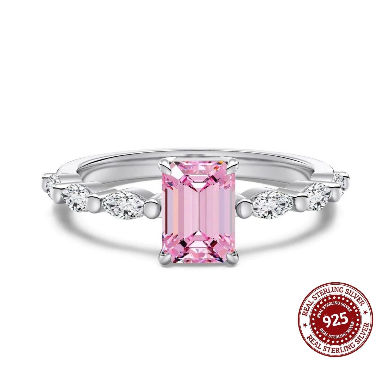 Silver ring with a pink gemstone on a white background, featuring a 'Real Sterling Silver 925' stamp.