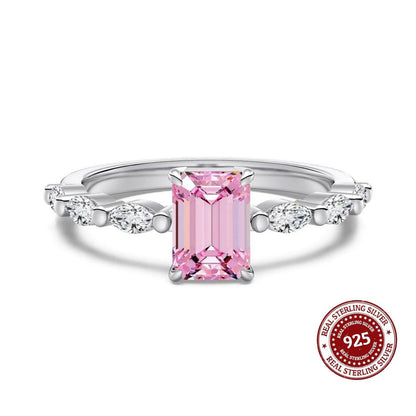 Silver ring with a pink gemstone on a white background, featuring a 'Real Sterling Silver 925' stamp.
