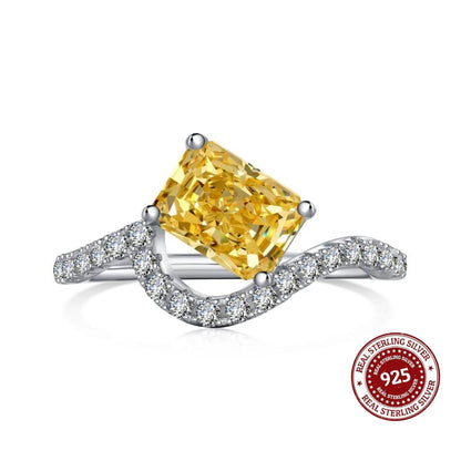 Ring with yellow gemstone and silver band on a white background, featuring a '925 Real Sterling Silver' stamp.