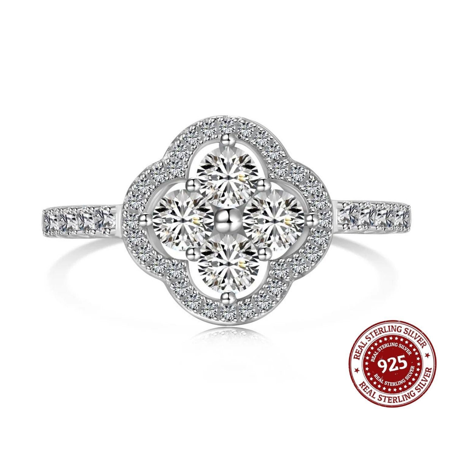 Silver ring with diamond-like stones on a white background, featuring a 'Real Sterling Silver 925' stamp.