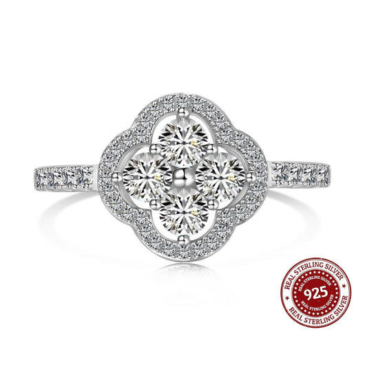 Silver ring with diamond-like stones on a white background, featuring a 'Real Sterling Silver 925' stamp.