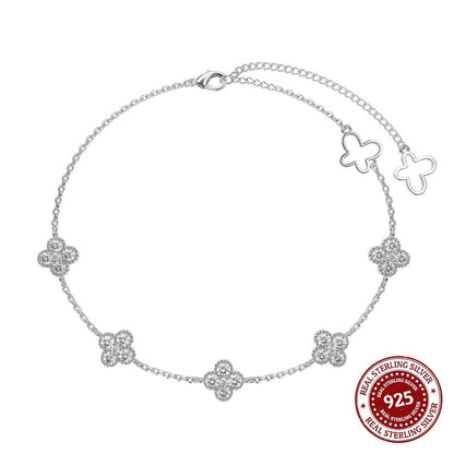 Silver bracelet with butterfly and flower designs on a white background, featuring a 'Real Sterling Silver' stamp.