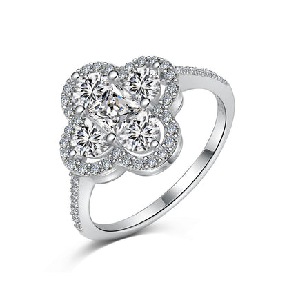 Silver clover-shaped ring with diamonds.
